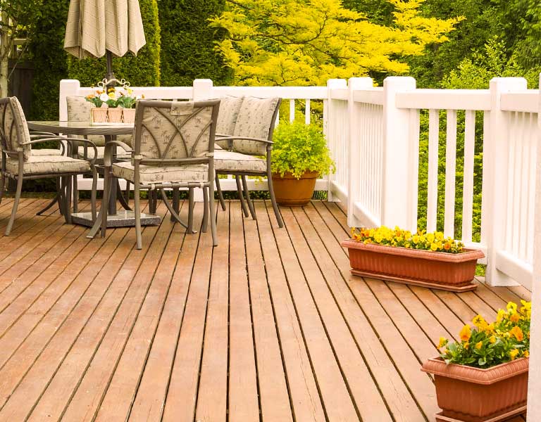 Hardwood deck outdoors with white railing
